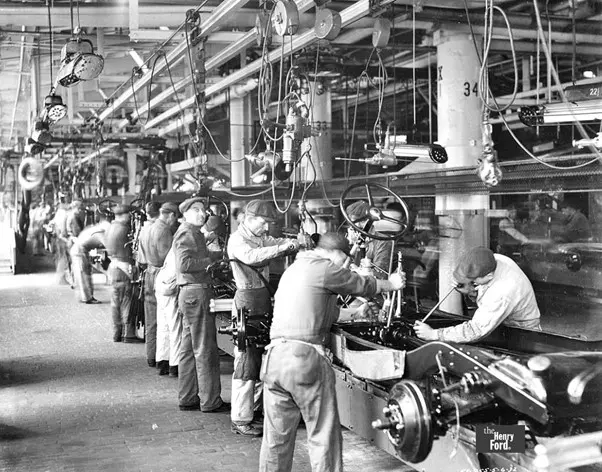 old photo of factory workers in black and white