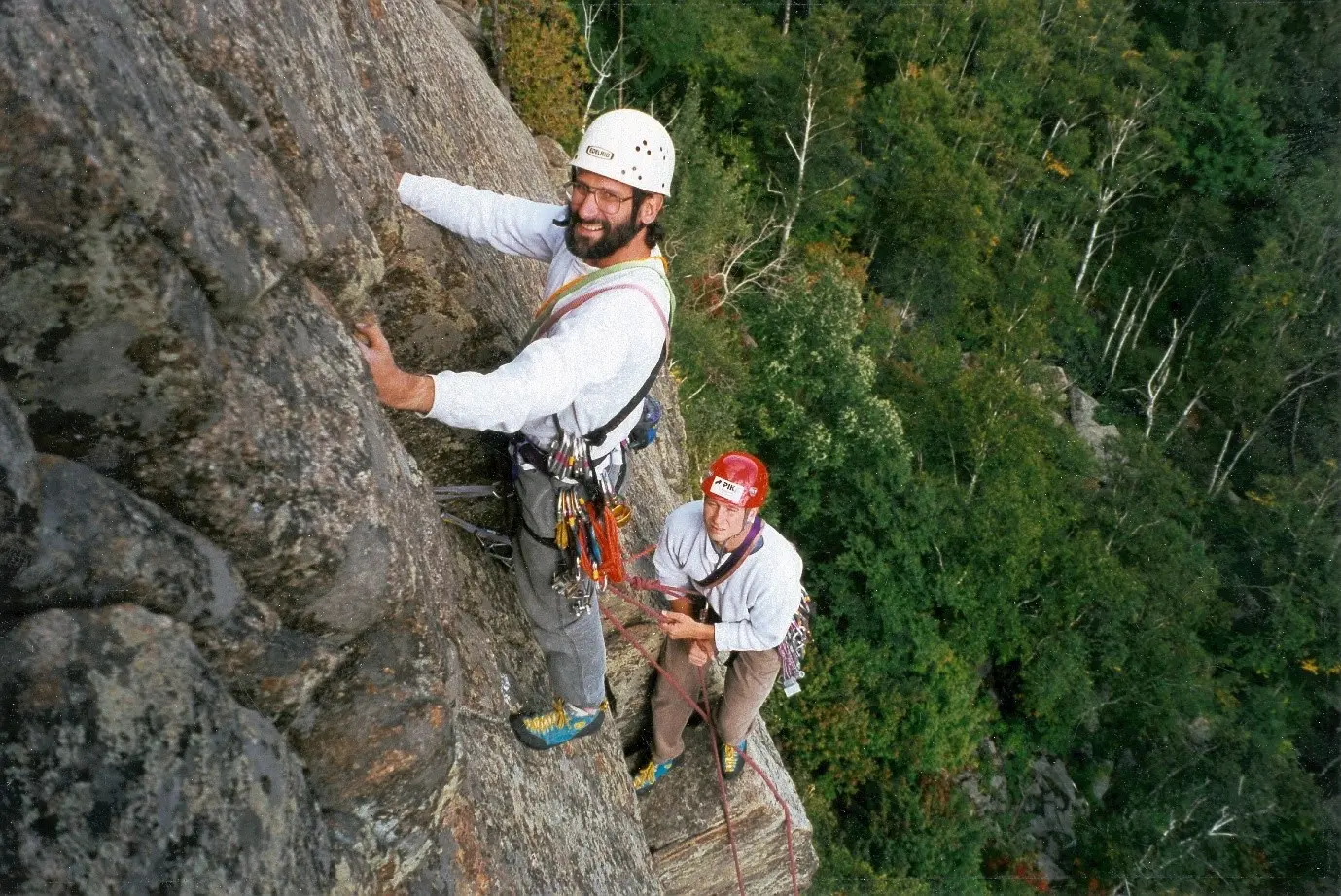 Photo of two buddies climbing, perspective is from above them looking down